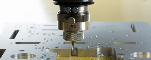 Close-up of a metal engraving process on aluminium using an ISx000 series CNC engraving machine