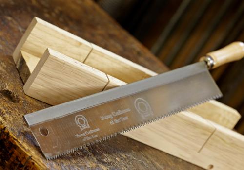 Metal rip saw engraved with logo on blade